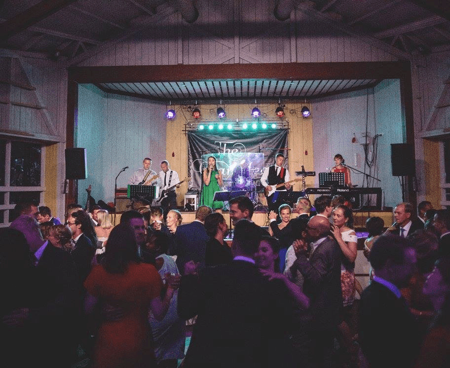 a group of people dancing at a wedding reception